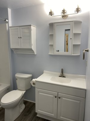 Mother-in-Law Suite/Accessory Dwelling Unit - Full scale remodel of a 500 square-foot Mother-in-Law suite. The existing unit was in BAD shape. It was dark and uninviting! The kitchen was very outdated and hardly functional and the bathroom was tiny! There was no laundry in the unit so we decided to built out a laundry closet which allowed us to extend the bathroom and make it much larger, fitting a 36" vanity, major upgrade from the 18" that was existing. It had old single pane windows and doors which we replaced to decrease heat loss and gas bills!
Modern farmhouse was the style of this remodel which we achieved with subtle details such as the bifold shutter doors, sliding barn door, mason jar light fixtures, and antique cabinet pulls. We kept things light and airy with white cabinets, light gray LVP flooring, and "Cool Sky" paint. This unit truly feels like a home now. We even renovated the landscaping to get a parking spot at the rear of the unit. Doing all of this increased rental value for our clients and they are thrilled with the new look! Mother-in-Law Suite/Accessory Dwelling Unit - Full scale remodel of a 500 square-foot Mother-in-Law suite. The existing unit was in BAD shape. It was dark and uninviting! The kitchen was very outdated and hardly functional and the bathroom was tiny! There was no laundry in the unit so we decided to built out a laundry closet which allowed us to extend the bathroom and make it much larger, fitting a 36" vanity, major upgrade from the 18" that was existing. It had old single pane windows and doors which we replaced to decrease heat loss and gas bills!
Modern farmhouse was the style of this remodel which we achieved with subtle details such as the bifold shutter doors, sliding barn door, mason jar light fixtures, and antique cabinet pulls. We kept things light and airy with white cabinets, light gray LVP flooring, and "Cool Sky" paint. This unit truly feels like a home now. We even renovated the landscaping to get a parking spot at the rear of the unit. Doing all of this increased rental value for our clients and they are thrilled with the new look!