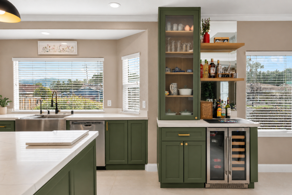Elegant Green Kitchen Remodel - A sophisticated kitchen transformation featuring deep green custom cabinetry, light countertops, brass accents, modern pendant lighting, and thoughtfully designed storage. The combination of natural tones and refined finishes creates a warm, distinctive kitchen with modern functionality and timeless character. Elegant Green Kitchen Remodel - A sophisticated kitchen transformation featuring deep green custom cabinetry, light countertops, brass accents, modern pendant lighting, and thoughtfully designed storage. The combination of natural tones and refined finishes creates a warm, distinctive kitchen with modern functionality and timeless character.