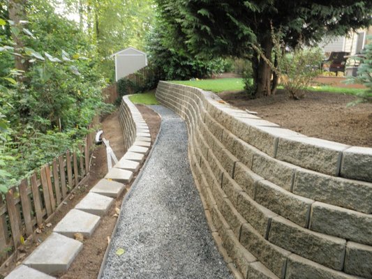 Retaining Wall - Find Retaining Wall Services in Everett, Marysville, Lake Stevens & Monroe, WA
COUNT ON US TO SELL YOU THE SUPPLIES YOU NEED
A retaining wall can complement any landscape. Stonewood Construction Services LLC will sell you the materials you need to build your custom hardscaping feature. When you visit us, we'll walk you through our product selection and explain your options. You can trust us to help you choose the right color and material for your home.
Discover what we have to offer you. Buy the retaining wall supplies you need in Everett, Marysville, Lake Stevens & Monroe, WA today.
A retaining wall is a structure that holds back earth from a building or other structure. Retaining walls stabilize soil and/or rock from downslope movement or erosion and provide support for vertical or near-vertical grade changes. Stonewood Construction Services, LLC can install the retaining wall your house needs.
We install Stone Brick Concrete or Timber Charlotte NC retainer walls, if that is what your project needs. No matter the height of the wall or the materials being used, our Lake Stevens, Everett, Marysville & Monroe, WA general contractor can take care of it.
4 REASONS TO GET A RETAINING WALL
You'll enjoy many perks of a retaining wall. Some of the more prominent benefits include:
Landscape preservation. A retaining wall will keep dirt in place so you won't have to worry about your yard washing away.
Customization options. We offer a wide array of designs to suit many different tastes.
Price. We'll help you choose the brand, style and color materials that work best with your budget.
Curb appeal. A retaining wall can make any landscape look refined and manicured. Retaining Wall - Find Retaining Wall Services in Everett, Marysville, Lake Stevens & Monroe, WA
COUNT ON US TO SELL YOU THE SUPPLIES YOU NEED
A retaining wall can complement any landscape. Stonewood Construction Services LLC will sell you the materials you need to build your custom hardscaping feature. When you visit us, we'll walk you through our product selection and explain your options. You can trust us to help you choose the right color and material for your home.
Discover what we have to offer you. Buy the retaining wall supplies you need in Everett, Marysville, Lake Stevens & Monroe, WA today.
A retaining wall is a structure that holds back earth from a building or other structure. Retaining walls stabilize soil and/or rock from downslope movement or erosion and provide support for vertical or near-vertical grade changes. Stonewood Construction Services, LLC can install the retaining wall your house needs.
We install Stone Brick Concrete or Timber Charlotte NC retainer walls, if that is what your project needs. No matter the height of the wall or the materials being used, our Lake Stevens, Everett, Marysville & Monroe, WA general contractor can take care of it.
4 REASONS TO GET A RETAINING WALL
You'll enjoy many perks of a retaining wall. Some of the more prominent benefits include:
Landscape preservation. A retaining wall will keep dirt in place so you won't have to worry about your yard washing away.
Customization options. We offer a wide array of designs to suit many different tastes.
Price. We'll help you choose the brand, style and color materials that work best with your budget.
Curb appeal. A retaining wall can make any landscape look refined and manicured.