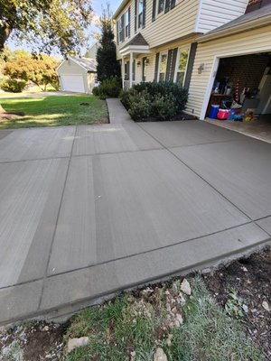 Modern Concrete Driveway Installation – Sterling, VA - We removed and replaced the existing driveway with a brand-new concrete slab, reinforced with rebar and poured to a 5" thickness for added durability.
We also improved water drainage and ensured clean lines from curb to garage for a polished, professional appearance. This project was completed on time and built to withstand years of vehicle traffic and weather exposure.
Bnts Construction handles driveway replacements, stamped finishes, and decorative borders throughout Northern Virginia. If you're dealing with cracks, settlement, or outdated curb appeal, give us a call for a free quote and inspection. Modern Concrete Driveway Installation – Sterling, VA - We removed and replaced the existing driveway with a brand-new concrete slab, reinforced with rebar and poured to a 5" thickness for added durability.
We also improved water drainage and ensured clean lines from curb to garage for a polished, professional appearance. This project was completed on time and built to withstand years of vehicle traffic and weather exposure.
Bnts Construction handles driveway replacements, stamped finishes, and decorative borders throughout Northern Virginia. If you're dealing with cracks, settlement, or outdated curb appeal, give us a call for a free quote and inspection.