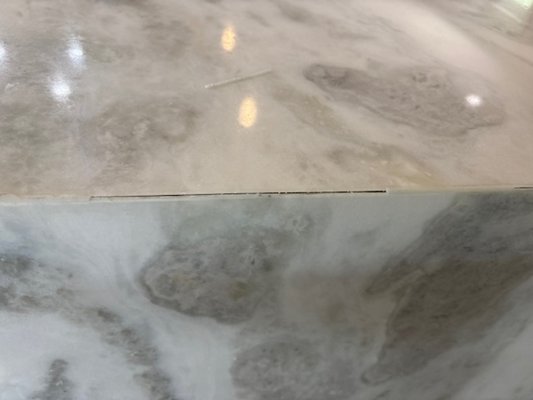 kitchen Island repair - This is a marble countertop with waterfall on the island that was coming apart at the mitered joints.

Our team went there, evaluated the damage, and repaired it quickly and efficiently.