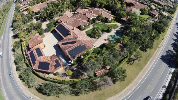 148 Solar Panel install - Palomar Solar & Roofing installed 148 panels on this beautiful home in Rancho Santa Fe, CA back in 2016.  We used the comp and frame method installing a composite shingle from the ridge all the way down and side to side under the solar arrays then we framed it with the existing clay tiles.