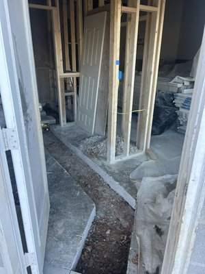 New Bathroom addition - This was a downstairs bathroom addition. We cut a trench for the new drain lines and removed the concrete. Dug a trench in the dirt. Install a toilet, shower, and sink drain. Line was tied into the existing sewer line outside before the septic