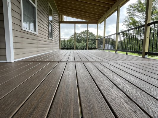 Custom 37’x10’ Trex Deck - This 37x10 ft custom Trex deck features a 7x15 ft recessed section integrated into the home’s layout for a seamless, high-end finish. Built with Trex Toasted Sand decking and Trex universal hidden fasteners for a clean look and long-lasting performance. The railing is Trex’s premium Charcoal Black system, adding a bold contrast. Wrapped in durable fiber cement fascia panels and topped with a full covered rooftop, this outdoor space is designed for year-round enjoyment and built to last. Custom 37’x10’ Trex Deck - This 37x10 ft custom Trex deck features a 7x15 ft recessed section integrated into the home’s layout for a seamless, high-end finish. Built with Trex Toasted Sand decking and Trex universal hidden fasteners for a clean look and long-lasting performance. The railing is Trex’s premium Charcoal Black system, adding a bold contrast. Wrapped in durable fiber cement fascia panels and topped with a full covered rooftop, this outdoor space is designed for year-round enjoyment and built to last.