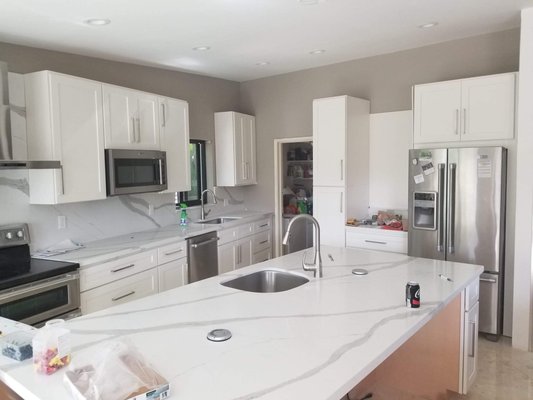 Kitchen Remodeling. - Costume kitchen remodeling at single family house with marble floor installation raise the drop ceiling and installed LD recessed lights. Quartz counter top and backsplash and costume walls.