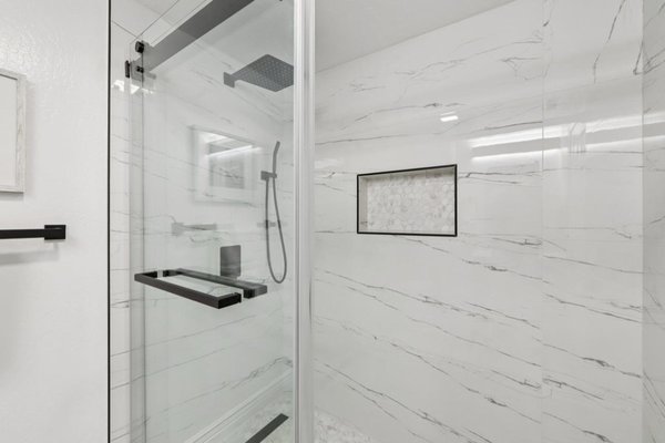 Full Bath Remodel San Ramon, CA - Full bathroom remodel in San Ramon, CA. Explore the finished spaces, including glass showers, rainfall and handheld shower fixtures, a soaking tub, marble-look tile, and updated vanities.