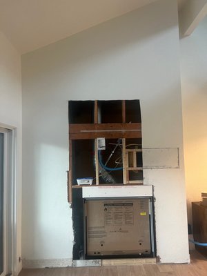 Broken lance Fireplace Remodel - Fireplace was completed with limestone thin veneer and finished with a white Portland mortar washed off to even with the stone. New wood mantle and new connections/power for TV and all electronics. new Fireplace insert.