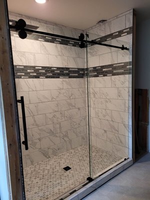 Custom tile shower build with glass sliding door - Here's a shower project my dad and I built together! Custom build materials were picked by the customer.