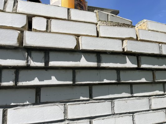 Chimney repair/repointing - This repair was done on a chimney customer need the top chimney repointing due to loose brick and failure of mortar cracking and falling out.