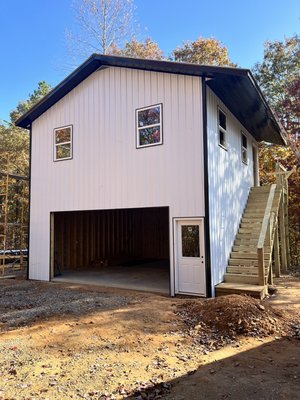 Custom Garage with Apartment - This Custom Garage with an Apartment, is over the top. This build is perfect for a studio, family that visits to have their own privacy, or even a man cave with a garage below! With a fully functional living space at 576 sqft and that much garage area as well. It features wood framing, metal siding, soffit and roofing (which gives better structural integrity), energy efficient insulation, full size kitchen and living area, mini-split heat/ac system, the list goes on with great features! If you’re thinking about building a garage, Rollins Construction Inc., has you covered. Give us a call today and let’s explore the possibilities for your next project. The consultation is free and the quality is standard. What are you waiting for? Custom Garage with Apartment - This Custom Garage with an Apartment, is over the top. This build is perfect for a studio, family that visits to have their own privacy, or even a man cave with a garage below! With a fully functional living space at 576 sqft and that much garage area as well. It features wood framing, metal siding, soffit and roofing (which gives better structural integrity), energy efficient insulation, full size kitchen and living area, mini-split heat/ac system, the list goes on with great features! If you’re thinking about building a garage, Rollins Construction Inc., has you covered. Give us a call today and let’s explore the possibilities for your next project. The consultation is free and the quality is standard. What are you waiting for?