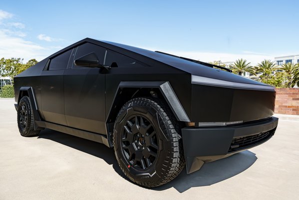 3M 2080 Matte Black Vinyl - Tesla CyberTruck - This striking matte black vinyl-wrapped Cybertruck turns heads with its bold and futuristic design. The sleek, stealthy finish enhances the truck's angular lines and sharp contours, giving it an aggressive yet sophisticated look. Perfectly blending innovation and style, this wrap transforms the already iconic vehicle into a unique automotive statement, showcasing both originality and craftsmanship. It's a must-see for car enthusiasts and anyone who appreciates cutting-edge design!