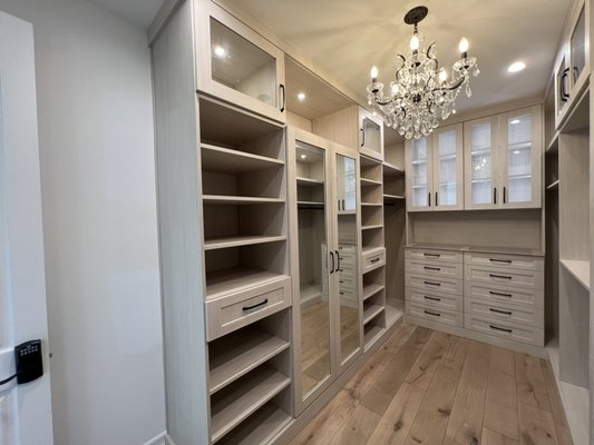 Walk in closet with lighting and glass counter - Complete overhaul of a walk in closet to a posh boutique closet that is inviting to walk in. Walk in closet with lighting and glass counter - Complete overhaul of a walk in closet to a posh boutique closet that is inviting to walk in.