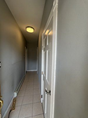 Hallway renovation - This renovation project transformed a 3x12 area with a complete upgrade in finishes and style. The flooring was revitalized with the installation of new tiles, providing a clean and durable surface. Three doors were replaced with new units, each finished with fresh trim for a refined look. Baseboard trim and crown molding were added throughout, enhancing the architectural detail and creating a polished finish. Finally, the ceilings and walls were painted with premium coatings, brightening the space and giving it a refreshed, modern appearance. The result is a seamless blend of function and elegance, showcasing quality craftsmanship from start to finish. Hallway renovation - This renovation project transformed a 3x12 area with a complete upgrade in finishes and style. The flooring was revitalized with the installation of new tiles, providing a clean and durable surface. Three doors were replaced with new units, each finished with fresh trim for a refined look. Baseboard trim and crown molding were added throughout, enhancing the architectural detail and creating a polished finish. Finally, the ceilings and walls were painted with premium coatings, brightening the space and giving it a refreshed, modern appearance. The result is a seamless blend of function and elegance, showcasing quality craftsmanship from start to finish.