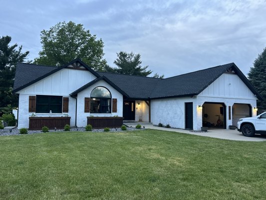 Luxury Exterior Transformation – GAF 50-Year Roof, James Hardie Board & Batten Siding, Custom Accents & Seamless Gutters – Northern Indiana - This project was a complete exterior transformation designed to elevate both the performance and appearance of the home using premium materials and professional installation methods. Located in Northern Indiana, this home received a full roofing, siding, paint, and exterior upgrade, turning an outdated exterior into a modern, high-end finish built to last.

The project began with a full roof replacement using a GAF 50-year HDZ roofing system, installed by certified professionals. We completed a full tear-off of the existing roofing materials to properly inspect the decking and ensure a solid foundation. Once confirmed, we installed a complete roofing system including high-performance underlayment, ice and water shield in critical areas, and precision-installed GAF HDZ shingles. This system provides superior wind resistance, long-term durability, and a clean, dimensional appearance that enhances curb appeal.

Next, we installed premium James Hardie board and batten siding across the home’s exterior. This siding system not only modernizes the look of the property but also provides long-lasting protection against the elements. Board and batten siding offers a bold, vertical design that gives the home a custom, high-end architectural feel while improving overall durability and energy efficiency.

To complete the exterior finish, we applied Sherwin-Williams premium self-washing paint. This advanced coating is designed to maintain a clean appearance over time by shedding dirt and debris naturally, reducing maintenance while keeping the home looking fresh and new. The color selection and professional application added depth and contrast to the siding and trim, further enhancing the home’s visual appeal.

Custom wood shutters and gable accents were installed to add unique character and detail to the home. These custom features elevate the overall design and create a cohesive, finished look that stands out from standard exterior renovations. Every accent was carefully measured, crafted, and installed to align with the architecture of the home.

We also installed new seamless gutters to ensure proper water management and long-term protection of the roof, siding, and foundation. Seamless gutters reduce the risk of leaks and improve the overall efficiency of the drainage system, especially during heavy rain and seasonal weather conditions common in Northern Indiana and Southern Michigan.

Throughout the project, our team focused heavily on preparation, property protection, and attention to detail. Landscaping, windows, and surrounding areas were protected during the installation process, and the job site was maintained clean and organized from start to finish.

This project highlights our ability to deliver full exterior renovations that combine roofing, siding, paint, and custom finish work into one seamless process. Homeowners in Elkhart, Goshen, Granger, Mishawaka, South Bend, Bristol, Middlebury, and surrounding areas trust Elkhart’s Best Home Services for high-quality exterior upgrades, storm damage restoration, and complete home transformations.

If you are looking for a contractor who can install a GAF 50-year roofing system, James Hardie siding, premium exterior paint, custom accents, and seamless gutters, this project is a perfect example of the craftsmanship, materials, and attention to detail we bring to every job.