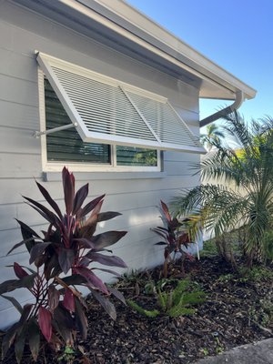 White Bahama Shutters St. Pete - ASC Aluminum installed these custom white Bahama shutters to add shade, privacy, and storm-ready protection to this Florida home. The sleek, airy design complements the exterior while providing year-round comfort and energy efficiency. Built from durable aluminum and engineered to withstand Florida weather, these shutters enhance both curb appeal and safety.