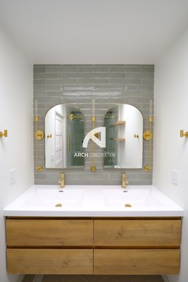 Bathroom Remodeling - Bathroom remodeling project, design/interior design/permit/construction. 
1. design/interior design/permit/construction/project management 

Project details:
In this bath remodeling project, we used customized hung doubled faucet vanity with all the goldish accessories such as faucets, lightings, hangers, handles, and toilet racks. Another excellent point is the pocket door for saving space compared to the traditional swing door. For the tiles, we used gray-greenish rectangular tiles on the tub's wall and the mirror's wall. We also chose mosaics to match the tile's color for the niche box. We used whole pieces of white porcelain marble on both sides of the tub to stand out on the main wall.