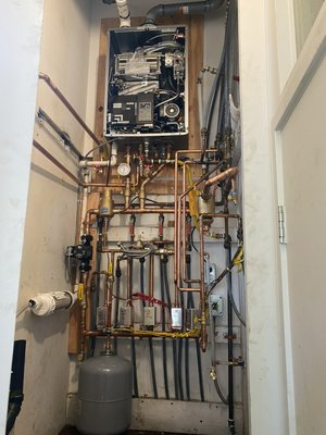 Boiler & hot water tank replacement to Combi boiler - This was a special install just because of how it was laid out before. We stripped everything out and even sawed off their platform for the tank. In the end we finished the install on time and passed the inspection. Boiler & hot water tank replacement to Combi boiler - This was a special install just because of how it was laid out before. We stripped everything out and even sawed off their platform for the tank. In the end we finished the install on time and passed the inspection.