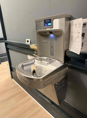 Water Fountain Install - Nestled within the bustling community of a thriving student housing facility, our skilled plumbing team recently completed a meticulous water fountain installation — bringing clean, reliable hydration directly to the students who call this place home.

From the very start, our team approached this project with both precision and purpose. Understanding that student housing demands practical, long-lasting solutions, we carefully assessed the existing plumbing infrastructure before breaking ground. What set this installation apart was the thoughtful groundwork required to make it all possible: our technicians strategically relocated the existing waste lines, a critical step that not only created the necessary spatial clearance for the new unit, but also ensured full compliance with plumbing codes and long-term system integrity.

At the heart of this installation is a modern water filtration system, seamlessly integrated into the new fountain setup. Every connection was carefully fitted and tested to guarantee consistent water pressure, leak-free performance, and — most importantly — clean, filtered drinking water that meets the highest standards of quality.
Our team takes great pride in projects like this one, where technical craftsmanship directly improves the day-to-day experience of the people we serve. The result is a water fountain that doesn't just function beautifully, but stands as a reliable fixture students can count on for years to come.
We're proud to deliver solutions that blend seamless utility with thoughtful execution — because every great community deserves infrastructure that works just as hard as the people living in it.