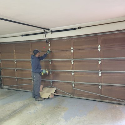 Garage door repair - This wood door was taken out and replaced with a modern style double steel insulated door.