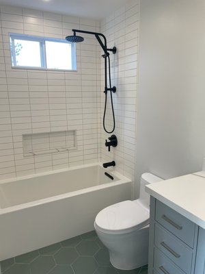 Leneve Pl, El Cerrito – Bathroom Remodel (Fall 2021) - This project was a full gut remodel of an outdated bathroom, redesigned for improved flow, comfort, and efficiency.
We started by removing the interior wall that had separated the bathtub/toilet from the vanity, opening up the space and creating a much larger, more unified feel. We also relocated the entry door to better maximize usable space inside the bathroom.
All plumbing was replaced, and we added two new dedicated electrical circuits—one for a GFCI outlet at the vanity, and another for a heated bidet. While we encountered a few structural surprises behind the walls, each issue was resolved without major delays.
We installed a large 32” bathtub and a new window to bring in natural light and ventilation.
Brad and Alicia were a pleasure to work with—clear in their vision and highly responsive. I provided the necessary drawings to obtain the building permit, while they handled the interior design.
We were able to complete this project in about 7 weeks.