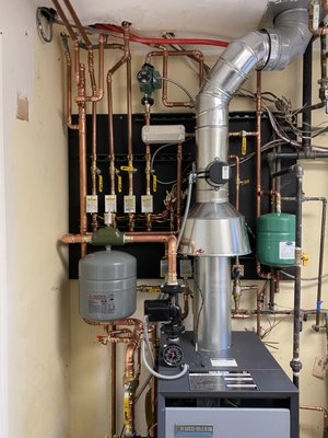 Boiler Installation BEFORE and AFTER - Top notch professional installation!  The first, cover picture is AFTER INSTALLATION.  The second picture is the BEFORE picture of the old boiler previously installed by another company.