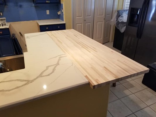 French Style Kitchen Remodel - A homeowner hired us and we took out a wall to open the kitchen, took out a wall to open the dining area. Then painted the kitchen cabinets. The Uppers were slightly distressed while the bottoms were not. A blend of granite and butcher block completed this French style kitchen.
