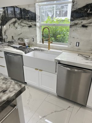 Kitchen remodel - This remodel was done on this kitchen to update for new home owners. New sink location under window with farm sink and double dishwasher. Prep sink with matching faucet in island.