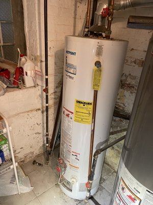 Hot Water Heater Replacement - Logan Square, Chicago, IL - September, 2021 - Water heater replacement in the wonderful neighborhood of Logan Square in Chicago.  Here are the before and after pictures.  The old water heater was leaking internally, causing the critical lighting components of the water heater to fail.  

They were experiencing the most dreadful condition, it's called the: “freezing cold fast shower” condition.  People do not know that their water heater requires yearly maintenance at minimum a flush once a year, or else sediment begins to collect in the tank.  Most people do not know this, but sediment and minerals naturally come into your home's water supply from its municipal origins. 

You can clearly see evidence of this if you were to open up one of your toilet tank lids and scrape with your finger the bottom of the tank.  Every Year 3 to 4 pounds of sediment and minerals enter your water heater. 

Imagine 3 pounds of rocks being boiled in a pot on your stove. What do you think will happen eventually?  The moving rocks will eventually beat through the pot as they did in this case.  Please flush your water heater yearly!