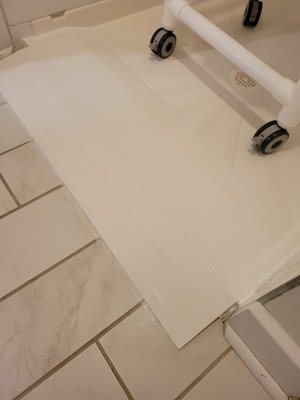 Wheelchair Ramp for Walk-In Shower - This Des Moines homeowner wanted to modify the curb on this walk-in shower, which is too low to stop water from running onto the floor, but too high to make wheelchair access easy.
I fabricated a ramp out of PVC lumber that allows easy rolling of the chair while also creating a barrier to contain the water. Wheelchair Ramp for Walk-In Shower - This Des Moines homeowner wanted to modify the curb on this walk-in shower, which is too low to stop water from running onto the floor, but too high to make wheelchair access easy.
I fabricated a ramp out of PVC lumber that allows easy rolling of the chair while also creating a barrier to contain the water.