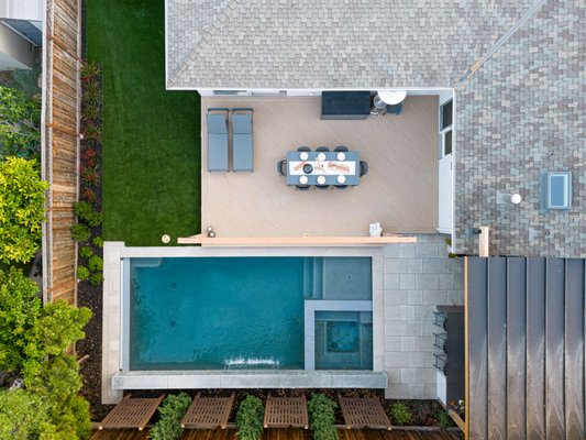 Backyard Remodel 2023 - Backyard remodels are common in our line of work because people want to enjoy all of their areas! This backyard remodel features an outdoor kitchen with a concrete waterfall counter. We built a gazebo to cover the entire outdoor kitchen and seating area. We also built a deck beside the synthetic lawn we installed and added privacy screens and plants around the pool. Backyard Remodel 2023 - Backyard remodels are common in our line of work because people want to enjoy all of their areas! This backyard remodel features an outdoor kitchen with a concrete waterfall counter. We built a gazebo to cover the entire outdoor kitchen and seating area. We also built a deck beside the synthetic lawn we installed and added privacy screens and plants around the pool.