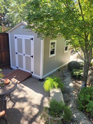 8'x12' Shed with Double Doors in front and Single door In back - Our clients needed a shed solution to fit in a tight area and still have access to the area behind the shed. We helped them custom design an 8'x12' shed with double doors in front and a single door in the back for access to the area behind the shed. Custom paint to match their home, a skirting upgrade, a long workbench and strategically placed windows finish off this beautiful, functional shed. 8'x12' Shed with Double Doors in front and Single door In back - Our clients needed a shed solution to fit in a tight area and still have access to the area behind the shed. We helped them custom design an 8'x12' shed with double doors in front and a single door in the back for access to the area behind the shed. Custom paint to match their home, a skirting upgrade, a long workbench and strategically placed windows finish off this beautiful, functional shed.