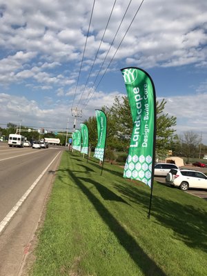 Mickman Brothers Flags - This project was awarded to us to create and print some large outdoor flags that would feature services provided by our client. The intent was to not only draw attention to the store front, but to keep the attention of the driver by stacking multiple flags along the highway.