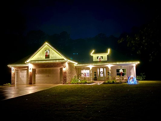 Roof lines - Our customer wanted their roofline and gable lit up. We also lit and hung their wreaths and wrapped their pillars. This house came out very beautiful.