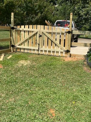 3 board wood fence - we build a 3-board wood fence with black welded wire of 2”x4”x48” squares. fence posts were set on concrete. fence installation was in Monroe, NC.