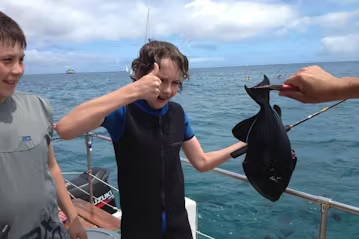 Fishing Adventures - Create fantastic family memories at sea on your Oahu vacation by combining a few ocean activities together. In addition to our family-friendly Reef Fishing activity, guests will have the opportunity to swim and snorkel with sea turtles & reef fish and witness our humpback whales in the winter months. These trips are great for families and groups gathered for birthdays, pre/post wedding celebrations, corporate events, and team building. Let us help make your day at sea perfect by arranging catering, bar, and transportation options. On our Hawaiian fishing charters, we use light spinning tackle catching and releasing the abundant reef fish over our coral and lava rock reefs. Anchored/moored in 15 – 25’ of very clear water, our location has lots of sea turtles to view along with the occasional monk seal and eagle ray on the surface. We cruise the south shore’s smooth waters for everyone’s comfort. Fishing Adventures - Create fantastic family memories at sea on your Oahu vacation by combining a few ocean activities together. In addition to our family-friendly Reef Fishing activity, guests will have the opportunity to swim and snorkel with sea turtles & reef fish and witness our humpback whales in the winter months. These trips are great for families and groups gathered for birthdays, pre/post wedding celebrations, corporate events, and team building. Let us help make your day at sea perfect by arranging catering, bar, and transportation options. On our Hawaiian fishing charters, we use light spinning tackle catching and releasing the abundant reef fish over our coral and lava rock reefs. Anchored/moored in 15 – 25’ of very clear water, our location has lots of sea turtles to view along with the occasional monk seal and eagle ray on the surface. We cruise the south shore’s smooth waters for everyone’s comfort.