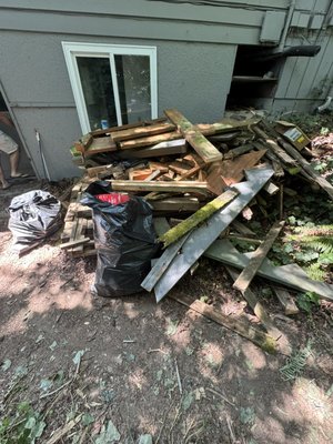 Same day junk removal and hauling - Removed and hauled away a large pile of mixed construction and demolition debris, including pressure-treated lumber, dimensional lumber, plywood, fence materials, sheet metal, bagged trash, and miscellaneous wood waste. Same day junk removal and hauling - Removed and hauled away a large pile of mixed construction and demolition debris, including pressure-treated lumber, dimensional lumber, plywood, fence materials, sheet metal, bagged trash, and miscellaneous wood waste.