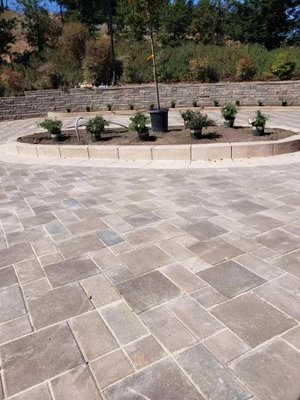 Hillside Pavers - We flattened out the side of our customers house in order to create more parking space. He wanted pavers with a small center covered with plants. Hillside Pavers - We flattened out the side of our customers house in order to create more parking space. He wanted pavers with a small center covered with plants.