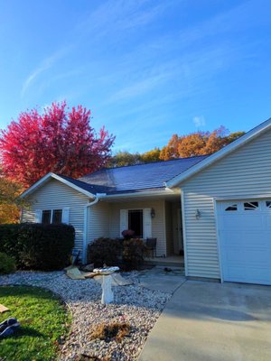 Cambridge – Roof Replacement with Solar Shingles and Whole-Home Backup - This Cambridge project involved a full roof replacement combined with solar shingles, battery storage, and whole-home backup power. The homeowner wanted a coordinated system that could provide resilience during outages without adding multiple layers of equipment to the roof over time.

Rather than installing a conventional roof first and adding solar and backup components later, the project was designed as a single, integrated system from the start. Treating the roof as the foundation allowed roofing, solar generation, battery storage, and backup power to be coordinated rather than retrofitted.

Integrated solar shingles were installed as part of the new roof, while impact-resistant asphalt shingles were used in non-solar areas to maintain consistent performance across the entire surface. Electrical pathways, penetrations, and waterproofing details were planned together to reduce complexity and long-term maintenance risk.

After completion, the homeowner’s insurance carrier reevaluated the property and reduced the annual premium by 39 percent, reflecting changes to roof materials, system integration, and overall risk profile. Insurance outcomes vary by provider and policy, but in this case, the roofing and system choices had a measurable impact.

This project demonstrates how roofing decisions influence energy and backup performance. By aligning roof replacement timing with solar and backup planning, the homeowner avoided redundant work and gained a system designed to perform reliably during both everyday use and extended outages.