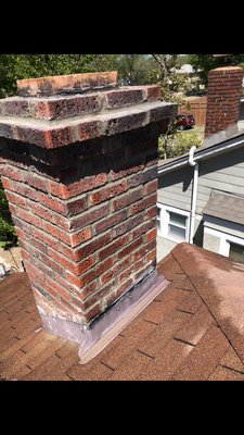 Chimney repair, tuck pointing - This chimney was in need of repairs, it had big holes in the top. The customer wanted to re-tuck point the whole chimney to get a perfect mortar match.