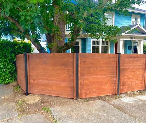 Horizontal Panel Fence - Our recent fencing project helped our client achieve her goal of giving her home a modern twist by opting for a horizontal fence design, paired with black stain posts and darker stained cedar boards to match the home's color scheme. Our approachable and professional team completed the installation in only 3 days, ensuring minimal disruption to the client's daily life. Horizontal Panel Fence - Our recent fencing project helped our client achieve her goal of giving her home a modern twist by opting for a horizontal fence design, paired with black stain posts and darker stained cedar boards to match the home's color scheme. Our approachable and professional team completed the installation in only 3 days, ensuring minimal disruption to the client's daily life.