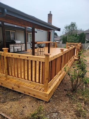 Custom Cedar Deck Build - Our crew worked on this custom cedar deck with a bar sitting area and deck cover