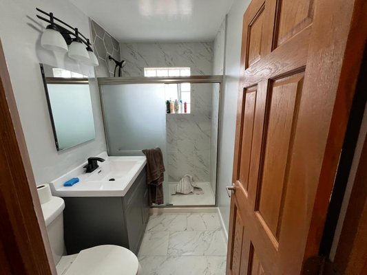 Bathroom Remodel (March 2022) - This remodel was done after we cleaned up mold in the old vanity. When there is a mold issue, all affected materials need to be replaced making it a great time to upgrade your space. We tore out the floor, tub, tile, vanity and light fixture to replace them with all new materials plus a fresh coat of paint. We and the client love how it turned out!