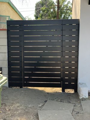 Custom Side Gate - For this newly built side gate, we used exterior pressure treated wood and clear red wood. On the finishing touches, we used black eggshell paint to give it a modern look. Custom Side Gate - For this newly built side gate, we used exterior pressure treated wood and clear red wood. On the finishing touches, we used black eggshell paint to give it a modern look.