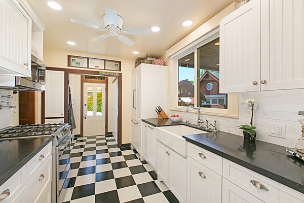 Historical Kitchen Remodel - This home was built in the early 1900s the kitchen had been upgraded in the 1980s but was in need of a complete Remodel that would also include the laundry room area which was right off of the kitchen into the new Design. We gutted the entire space custom cabinets were designed to accommodate the owners need for storage. We also had custom Bifold Doors built to match the cabinets made to close off the laundry area when that space was not in use