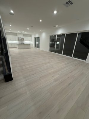 Essen Loraine SPC Flooring Installation - Lake Forest - For this modern Lake Forest residence, we installed 1,330 square feet of Essen Loraine 12mm SPC luxury vinyl plank flooring. This durable, waterproof flooring provides a sleek, contemporary look throughout the open-concept living area and kitchen. The project features precision cutting around the sliding glass door tracks and a clean transition to the plush carpeted staircase. We prioritized a proper underlayment for maximum sound dampening and stability, ensuring a high-end feel in every room. Essen Loraine SPC Flooring Installation - Lake Forest - For this modern Lake Forest residence, we installed 1,330 square feet of Essen Loraine 12mm SPC luxury vinyl plank flooring. This durable, waterproof flooring provides a sleek, contemporary look throughout the open-concept living area and kitchen. The project features precision cutting around the sliding glass door tracks and a clean transition to the plush carpeted staircase. We prioritized a proper underlayment for maximum sound dampening and stability, ensuring a high-end feel in every room.