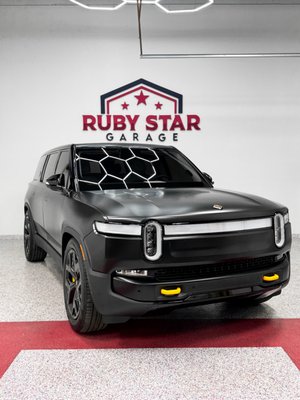 XPEL Stealth PPF on Rivian R1S - This Rivian R1S received comprehensive protection with XPEL Stealth Paint Protection Film, transforming its original glossy finish. To provide even greater defense against contaminants and simplify maintenance, we applied a ceramic coating on the film. Additionally, we extended the ceramic coating to the wheels and glass, ensuring the entire vehicle enjoys enhanced durability and ease of care. XPEL Stealth PPF on Rivian R1S - This Rivian R1S received comprehensive protection with XPEL Stealth Paint Protection Film, transforming its original glossy finish. To provide even greater defense against contaminants and simplify maintenance, we applied a ceramic coating on the film. Additionally, we extended the ceramic coating to the wheels and glass, ensuring the entire vehicle enjoys enhanced durability and ease of care.