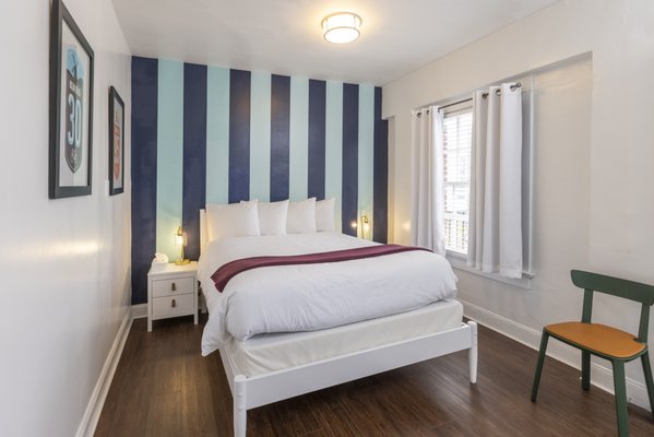 Deluxe Queen with Street View and Ensuite Bathroom - Our cozy Deluxe Queen Rooms feature a queen-size bed and a spacious bathroom. Enjoy city views, built-in vanity mirrors, window shades, and a 43" Class LED 4K UHD Smart TV with streaming services. These rooms blend a contemporary feel with historical charm, ensuring a comfortable and stylish stay.