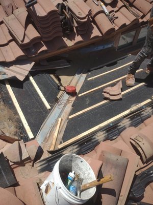 Tile Repair - The area of repair was on the turret part of the roof where expertise in this field is called for.  If tiles are broken and need replacement, they need to be cut precisely to fit perfectly.  Our proficient and experienced crew replaced the repair area with 40# underlayment and replaced the tiles.