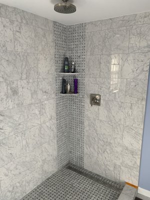 Bathroom remodeling - This bathroom is a piece of art. We double the size of the bathroom and relocate the shower head to the ceiling, we use a straight drain and a select Imported tile from Italy. Everything on this little bathroom was made with care.