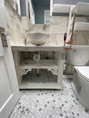 Custom bathroom - Custom vanity, stone shelving ,marble tile , vessel bowl, with a unique faucet that have a smooth water flow Custom bathroom - Custom vanity, stone shelving ,marble tile , vessel bowl, with a unique faucet that have a smooth water flow